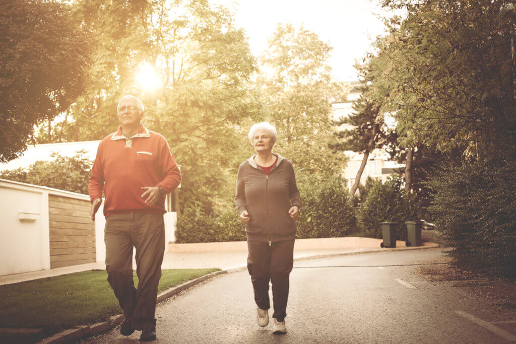 Elderly Couple Taking A Brisk Walk