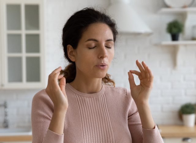 Woman Deep Breathing Exercise In The Kitchen Before Eating, Concept Of How To Lose 10 Pounds Fast