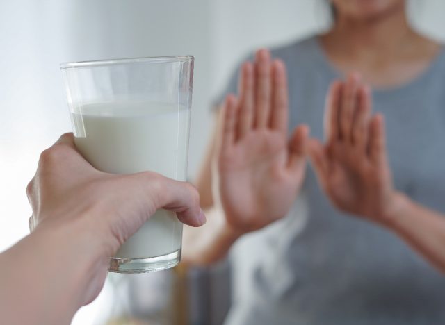 Woman Refuses A Glass Of Milk Reducing Dairy, Concept Of Tips To Lose 10 Pounds Fast