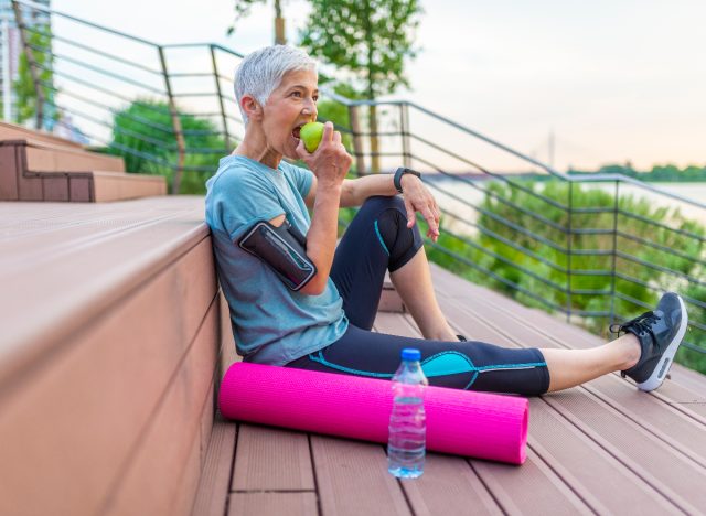 Woman Eating Apple After Workout