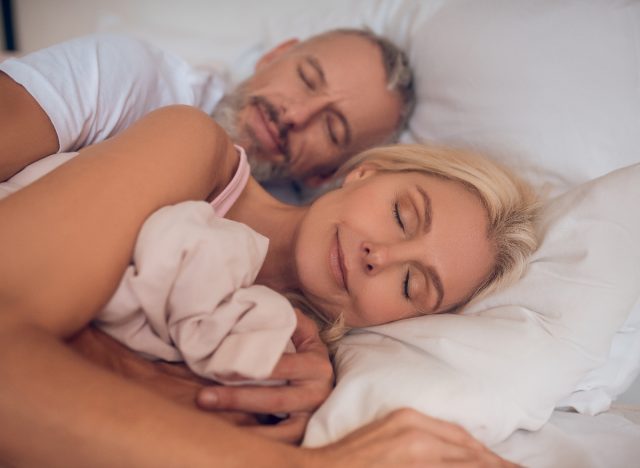 mature couple sleeping peacefully, demonstrating habits to maintain muscle mass after 50