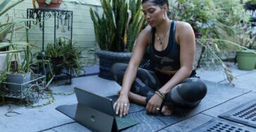 Person using tablet on a yoga mat