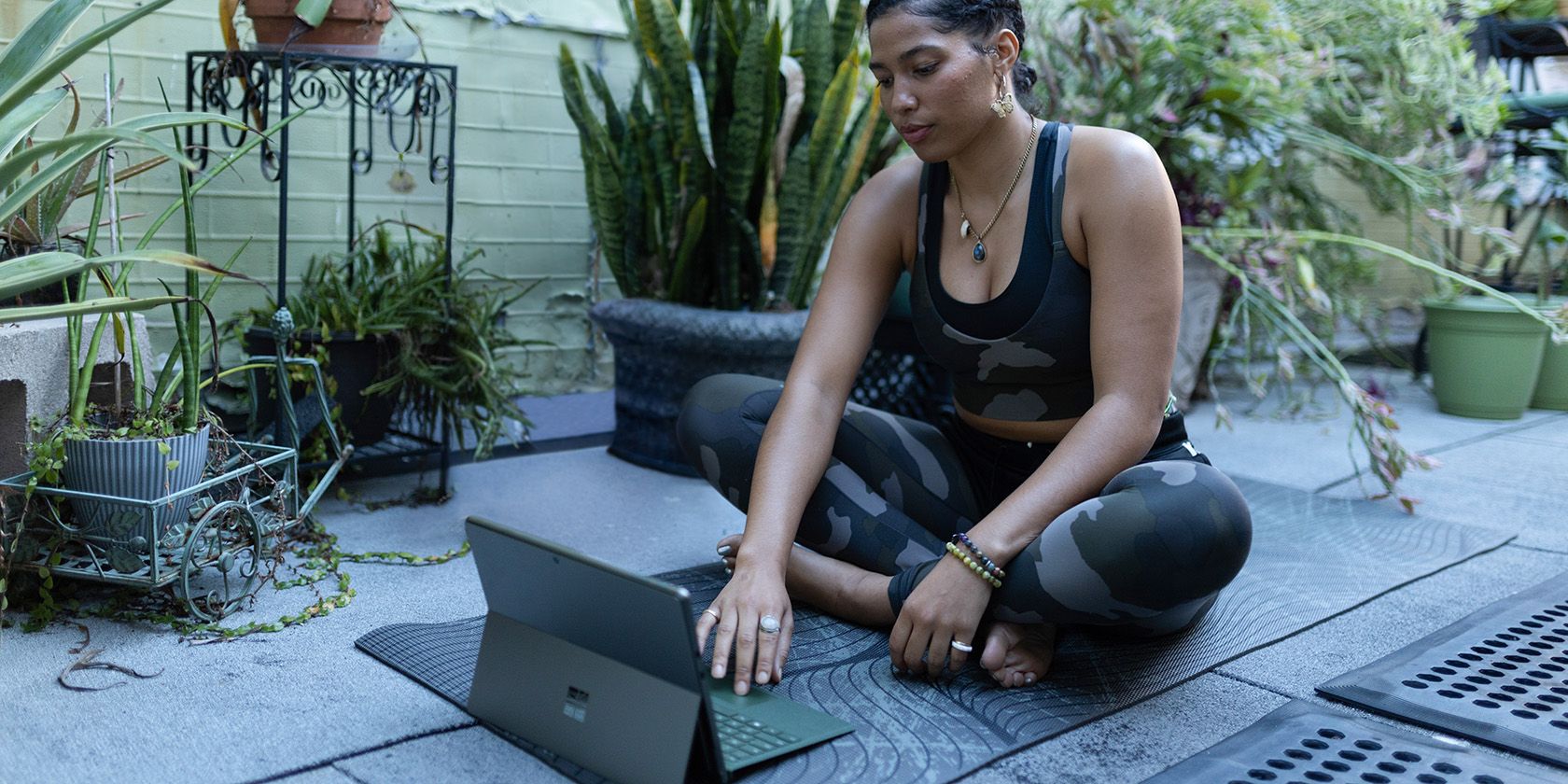 Person using tablet on a yoga mat