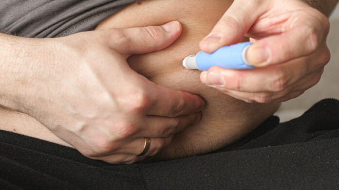 obese fat man preparing Semaglutide Ozempic injection control blood sugar levels