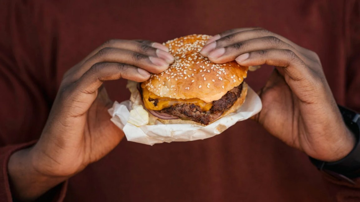 A person eating a burger.