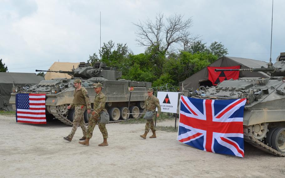 British and American soldiers walk out of a command post set up for a multinational training exercise Thursday, April 20, 2023 at Fort Hood, Texas.