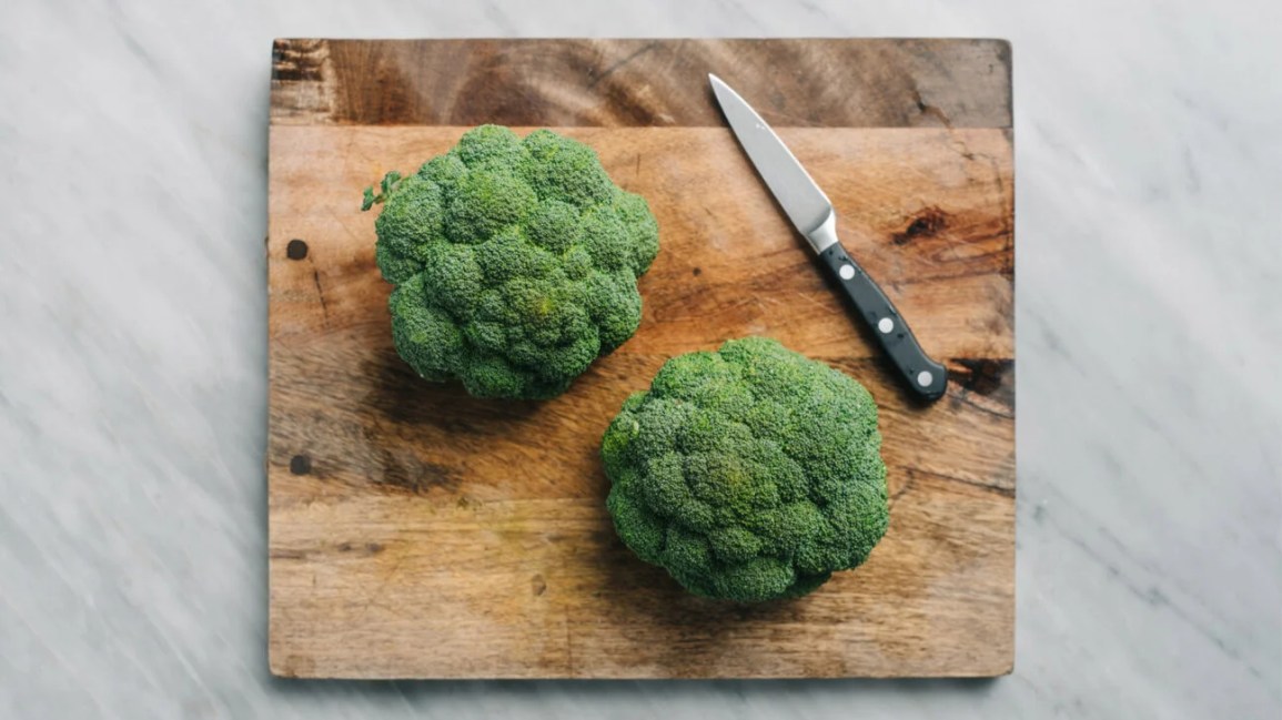 Broccoli on a cutting board.
