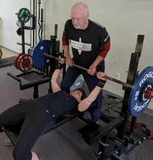 Peter Hubbard, 85, spots his wife, Nona, 61, during a recent weightlifting workout.  The two will compete in the Powerlifting America New Hampshire State Championship at Lift Free or Die Gym in Dover beginning at 9 a.m.